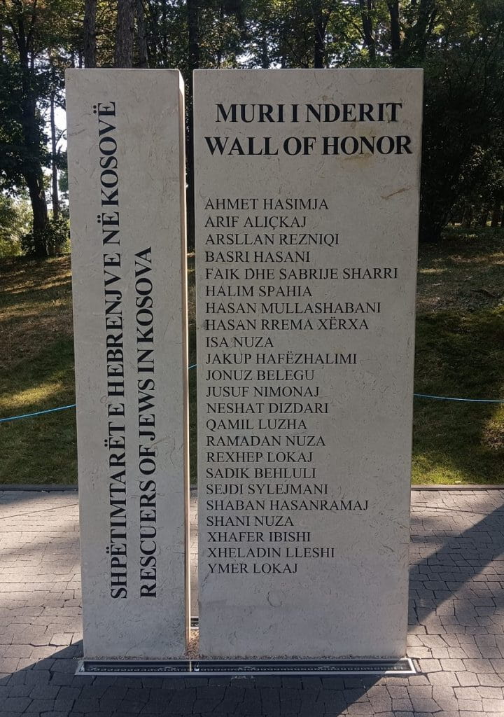 <br />
<br />
<br />
Ky memorial është ndërtuar dhe inaguruar para vetëm dy vitesh, më 23 gusht 2023, me nismën e Shoqatës për Miqësi Kosovë – Izrael dhe Fondacionit Shqiptaro – Amerikan. I quajtur sipas mbishkrimit dygjuhësh “Muri i Nderit/Wall of Honor”, ky memorial përbëhet nga një pllakë rreth dy metra e gjysmë e lartë, në krah të të cilit është shkruar: “Shpëtimtarët e hebrenjve në Kosovë/Rescuers of Jews in Kosova”. <br />
<br />
Në atë pllakë përkujtimore, janë shënuar emrat e 24 shqiptarëve të Kosovës që kanë shpëtuar hebrenjë gjatë luftës.